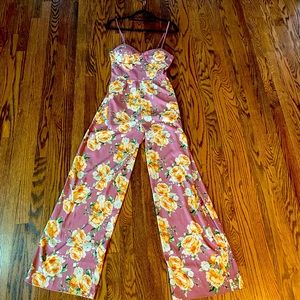 Never worn.  Floral trendy romper. Size small. Perfect for any occasion!